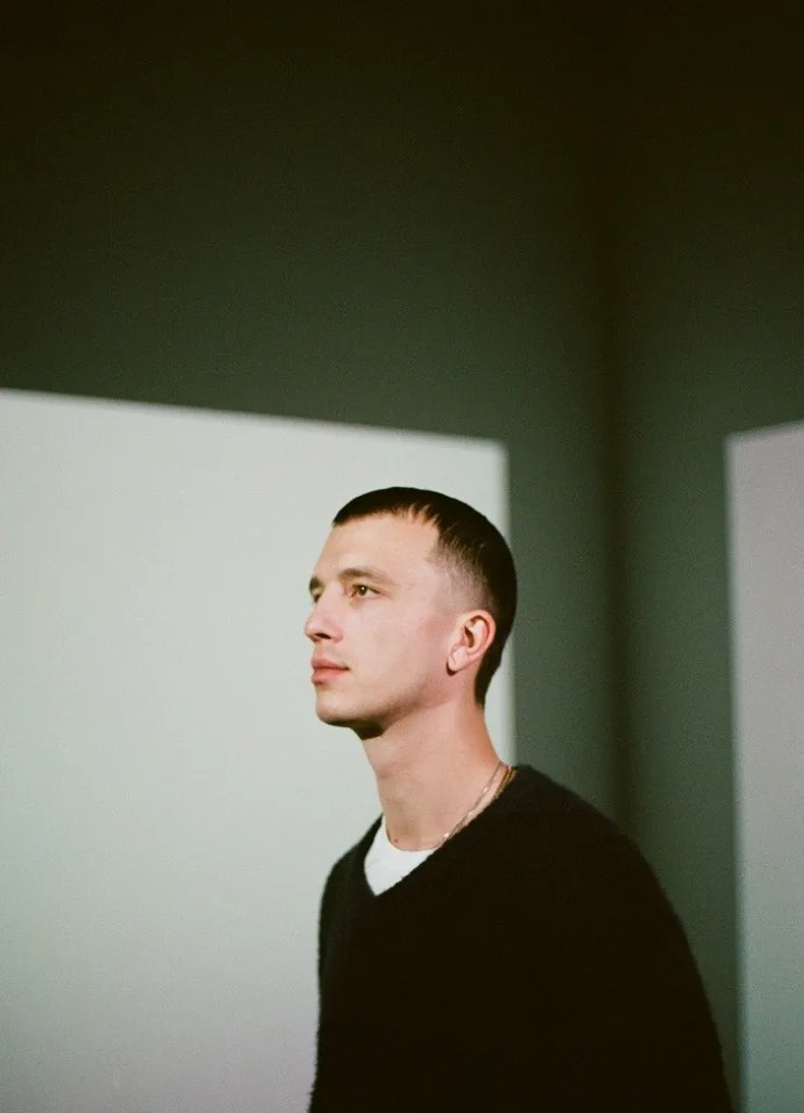 Lucas Brunner, partner at Alpgency, in profile against a minimalist interior.